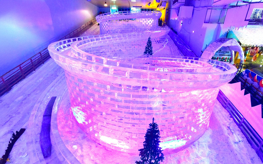 Glacier luge track with ice walls and snow at Singapore Snow City.
