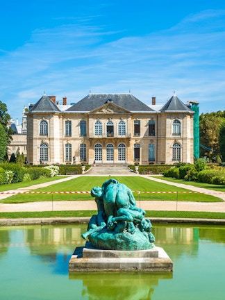 Rodin Museum in Paris with sculpture in foreground and historic building behind.