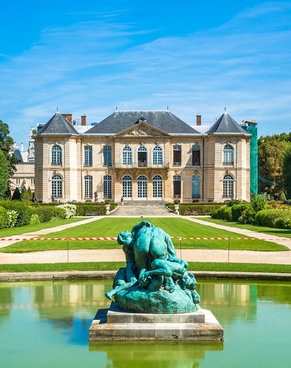 Rodin Museum in Paris with sculpture in foreground and historic building behind.