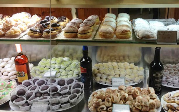 Pastries and Marsala wine in a Sicilian bakery display, Erice and Marsala tour.