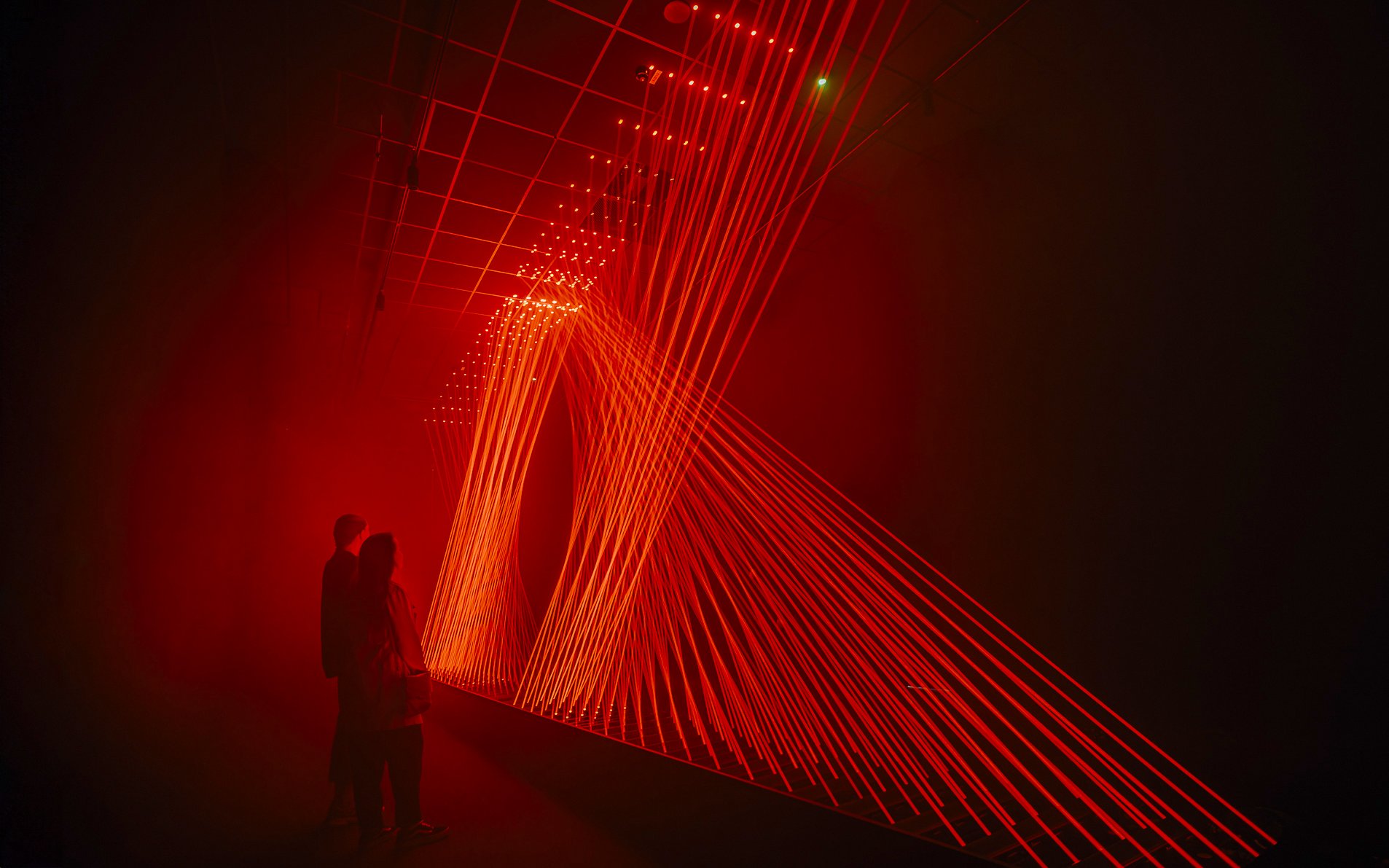Guests viewing red light installation at Signal Space Digital Art Gallery.