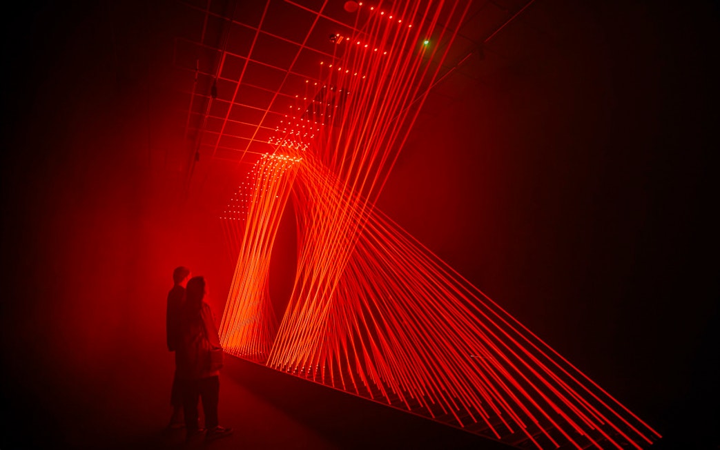 Guests viewing red light installation at Signal Space Digital Art Gallery.
