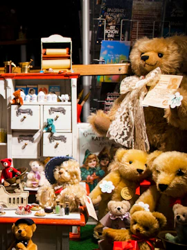 Teddy bears and vintage toys displayed on a magazine shelf.