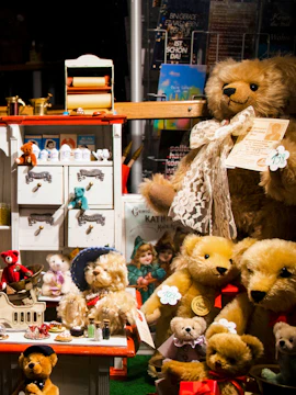 Teddy bears and vintage toys displayed on a magazine shelf.