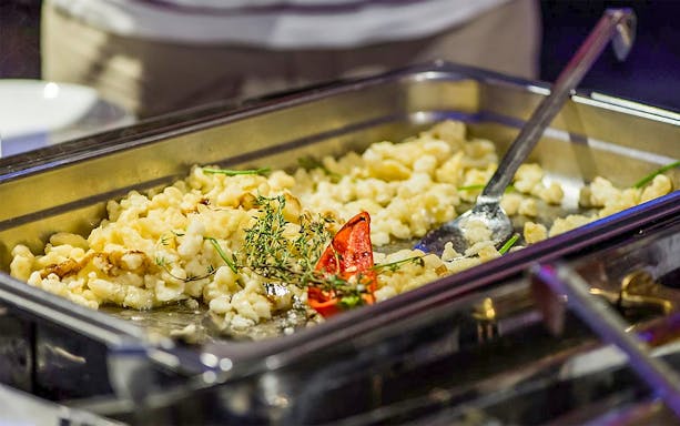 Hungarian dumplings with herbs and peppers on Budapest dinner cruise.