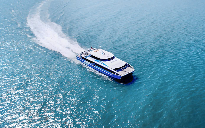 Ferry approaching Rottnest Island with ocean view, part of the guided bus tour from Perth or Fremantle.