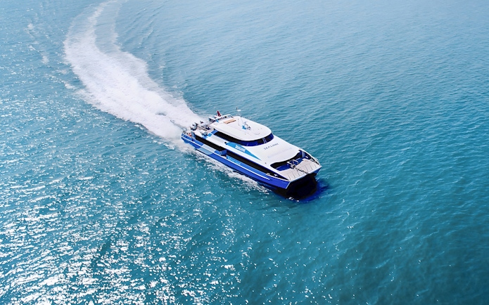 Ferry approaching Rottnest Island with ocean view, part of the guided bus tour from Perth or Fremantle.