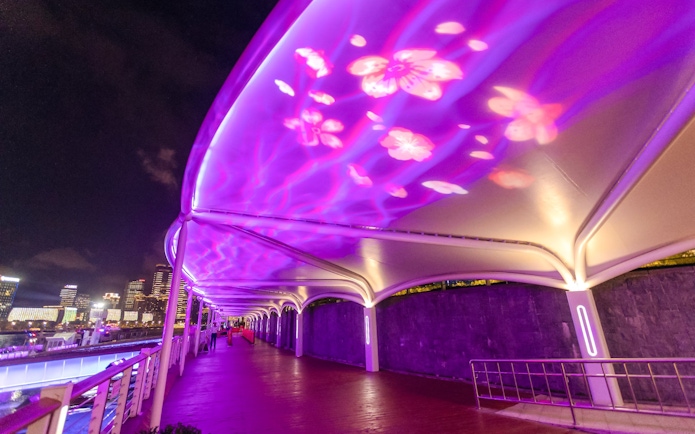 Illuminated walkway with floral projections leading to Oriental Pearl Tower cruise port, Shanghai.