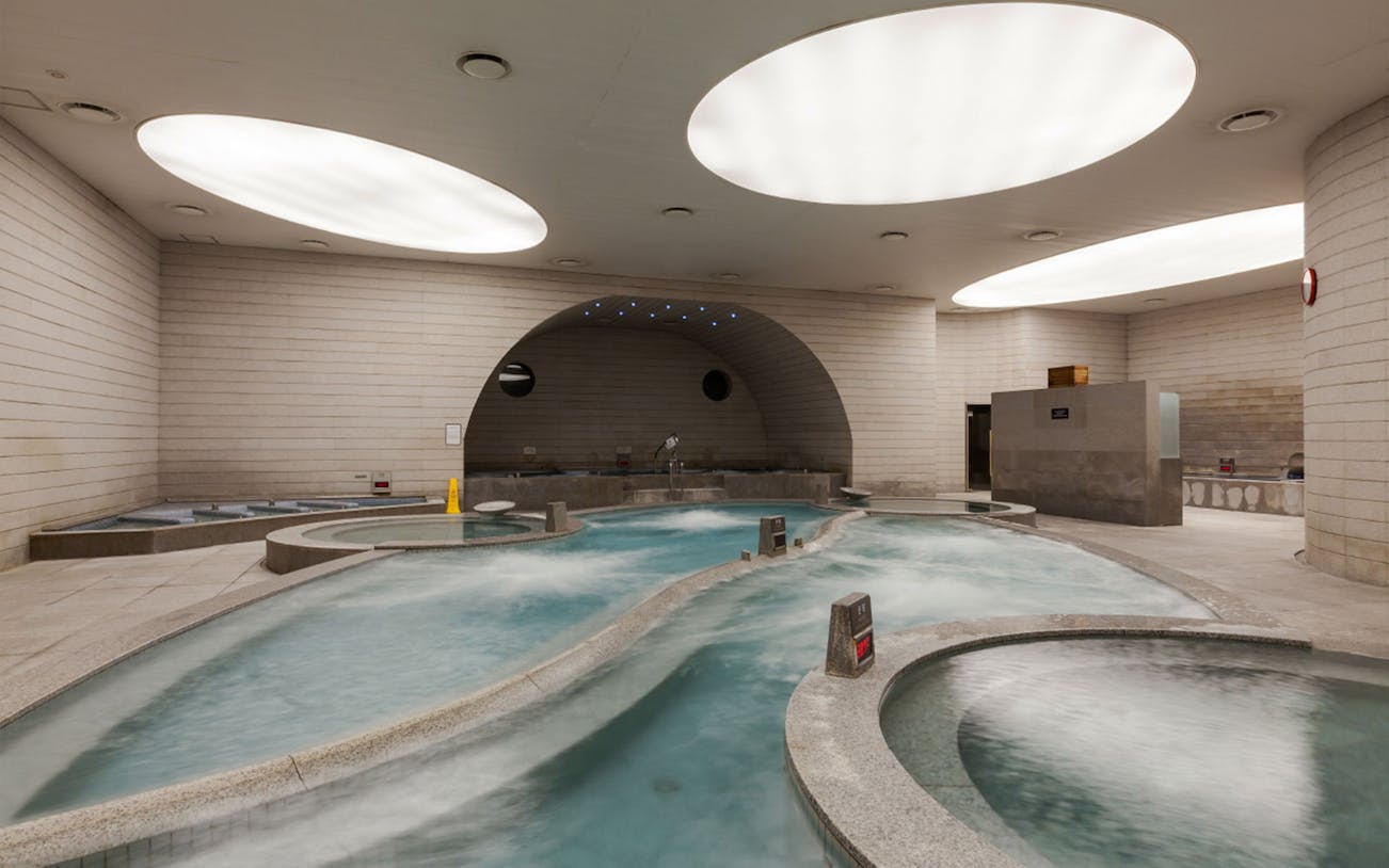 Indoor spa pools at Spa Land Centum City, Busan, featuring modern architecture and relaxation areas.