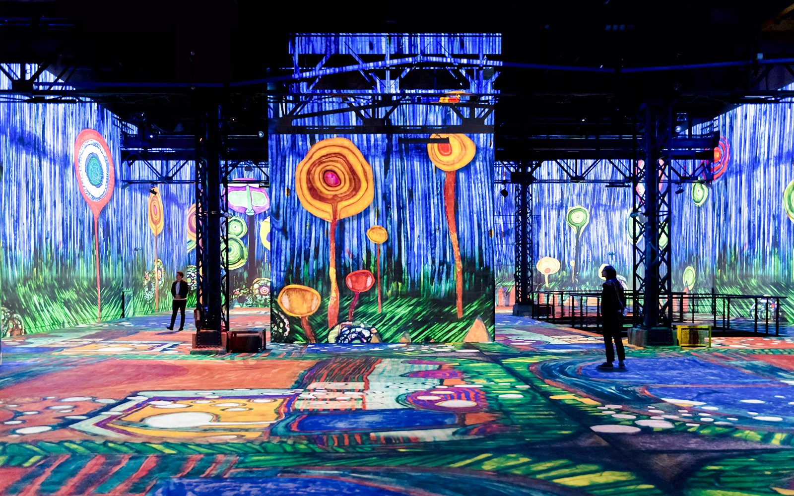 Immersive digital art projections at Atelier Des Lumières, Paris, featuring vibrant abstract designs.