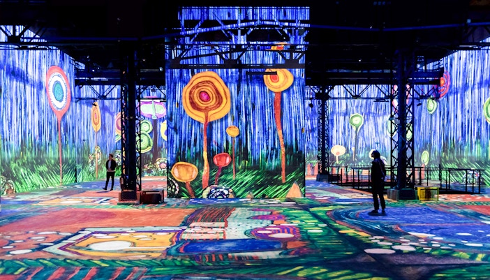 Immersive digital art projections at Atelier Des Lumières, Paris, featuring vibrant abstract designs.