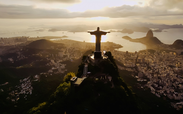 Christ the Redeemer overlooking Rio de Janeiro at dusk.