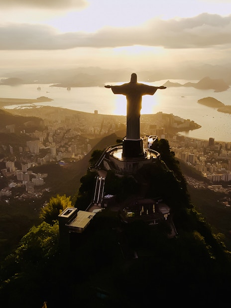 Christ the Redeemer overlooking Rio de Janeiro at dusk.