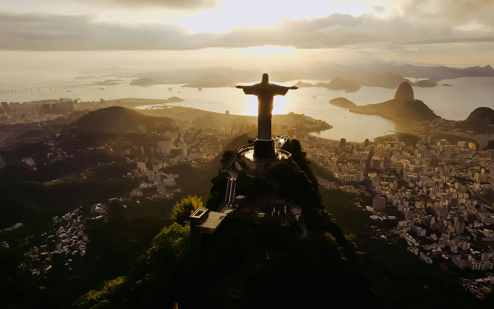 Christ the Redeemer overlooking Rio de Janeiro at dusk.