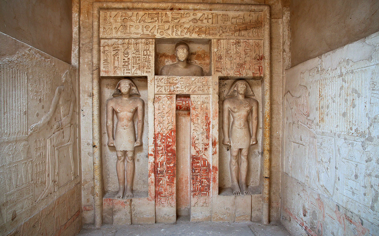 Ancient Egyptian statues and hieroglyphs in Saqqara necropolis, Egypt.
