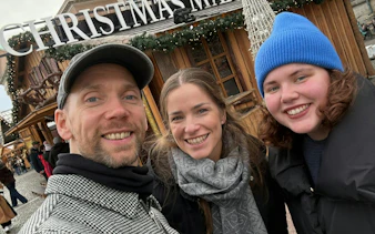 Visitors at a Christmas market in Copenhagen during the Time Travelers Cronophone city exploration game.