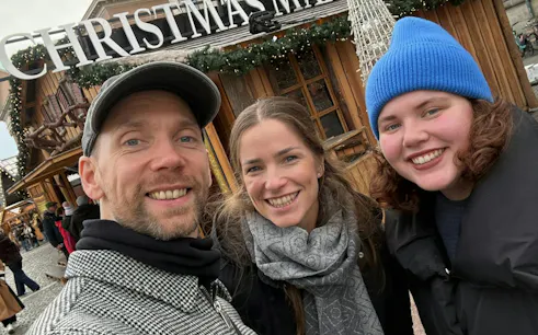Visitors at a Christmas market in Copenhagen during the Time Travelers Cronophone city exploration game.