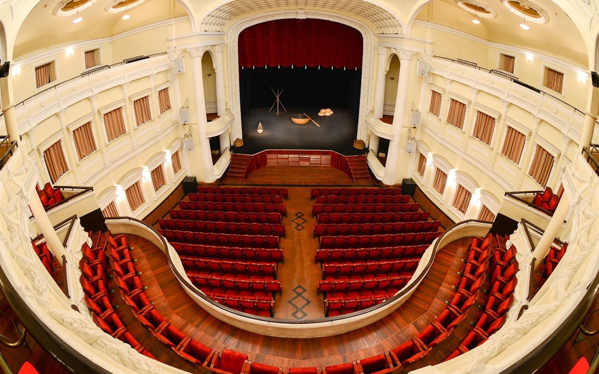 Stage view at A O Show circus in Vietnam with red seats and ornate balcony.