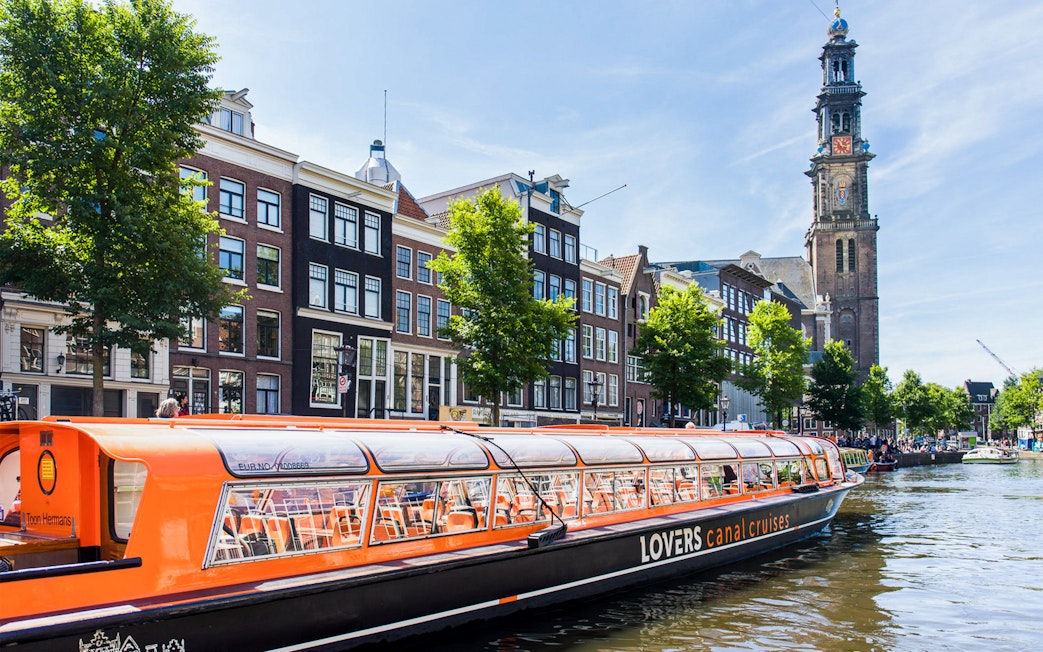 Canal cruise passing Westerkerk Church in Amsterdam.