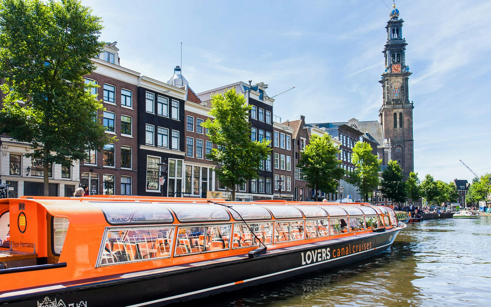 Canal cruise passing Westerkerk Church in Amsterdam.
