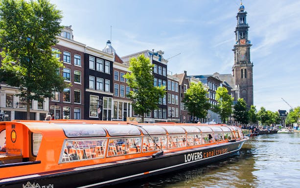 Canal cruise passing Westerkerk Church in Amsterdam.