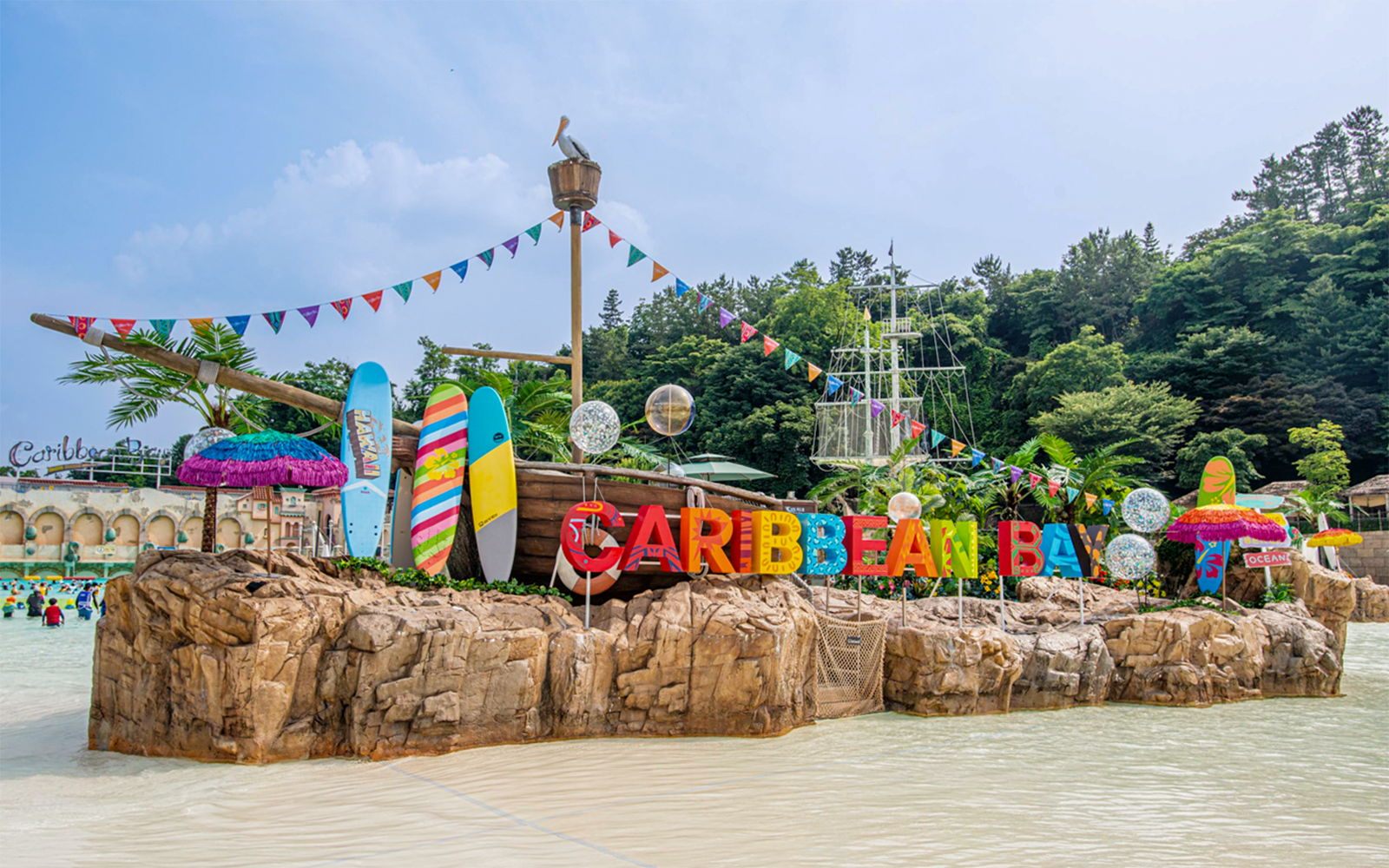 Caribbean Bay Water Park entrance with colorful surfboards and pirate ship theme.