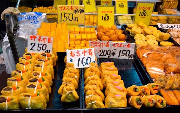 Assorted Japanese street food displayed at a market stall in Osaka.