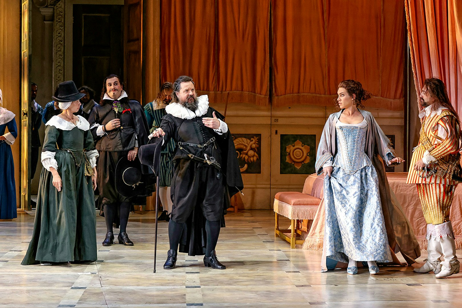 Actors in period costumes perform a scene from "The Marriage of Figaro" on stage.