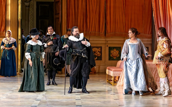 Actors in period costumes perform a scene from "The Marriage of Figaro" on stage.