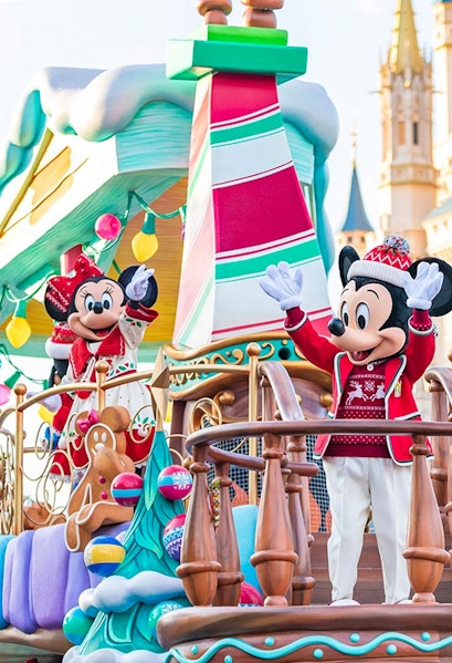 Characters in festive attire on a holiday-themed float at Tokyo Disney Resort.