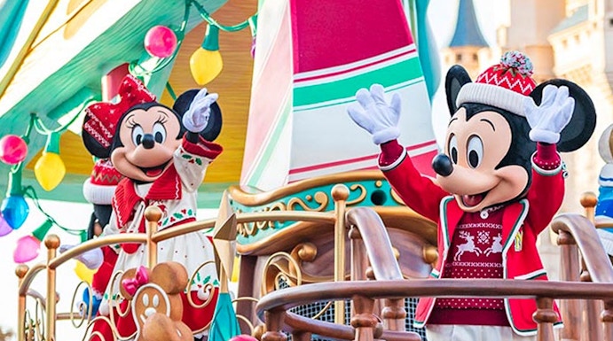 Characters in festive attire on a holiday-themed float at Tokyo Disney Resort.