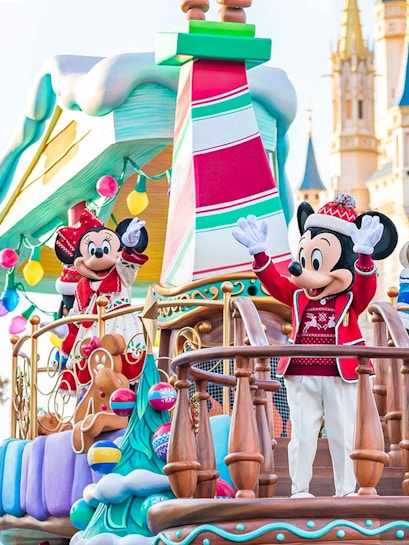 Characters in festive attire on a holiday-themed float at Tokyo Disney Resort.