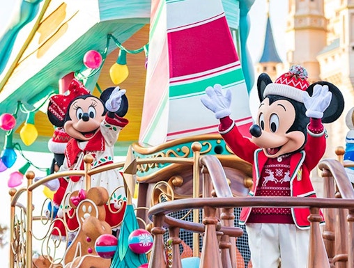 Characters in festive attire on a holiday-themed float at Tokyo Disney Resort.