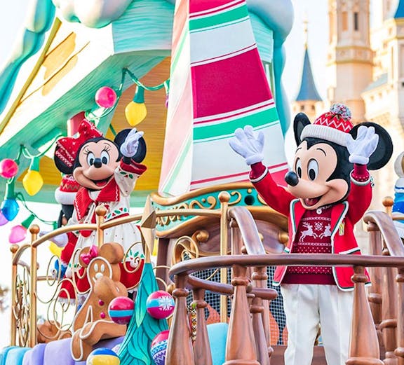 Characters in festive attire on a holiday-themed float at Tokyo Disney Resort.