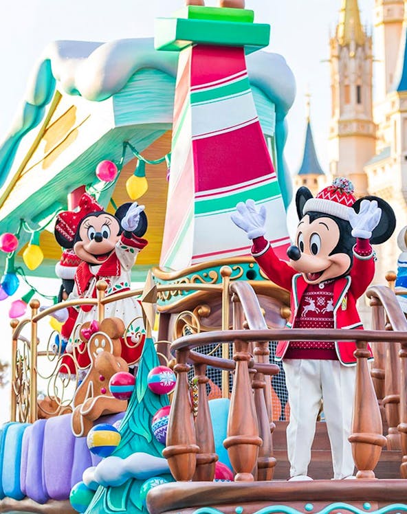 Characters in festive attire on a holiday-themed float at Tokyo Disney Resort.