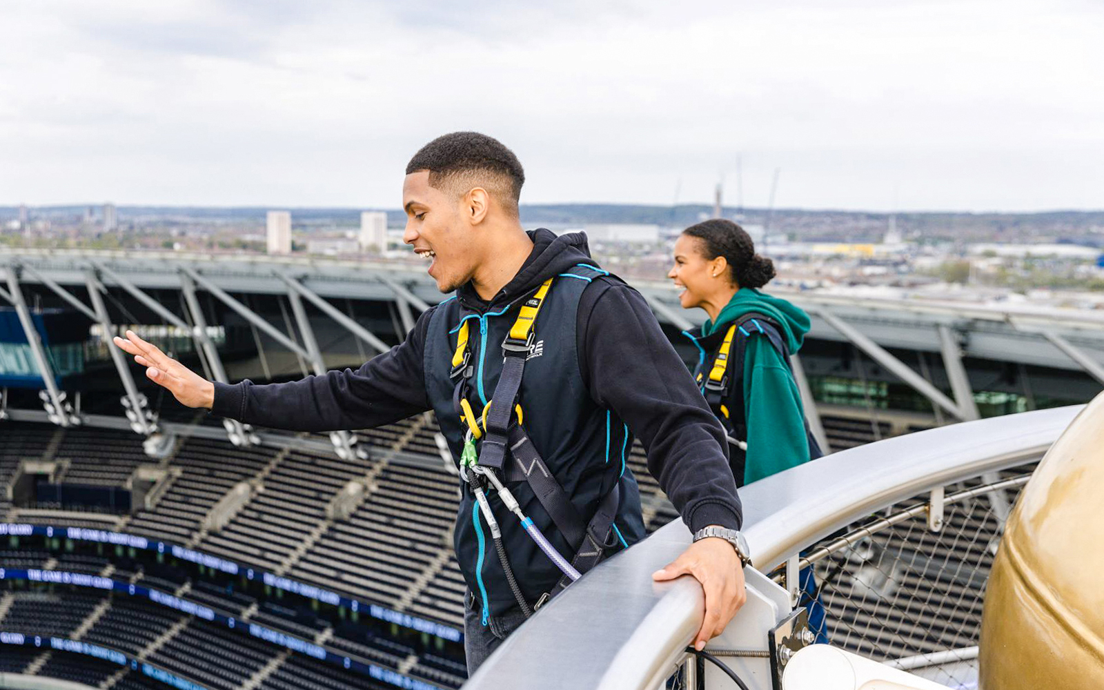Participants enjoying The Dare Skywalk experience at a stadium rooftop.