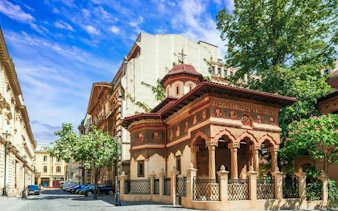 Bucharest's Armenian Quarter street with historic architecture and ornate church.