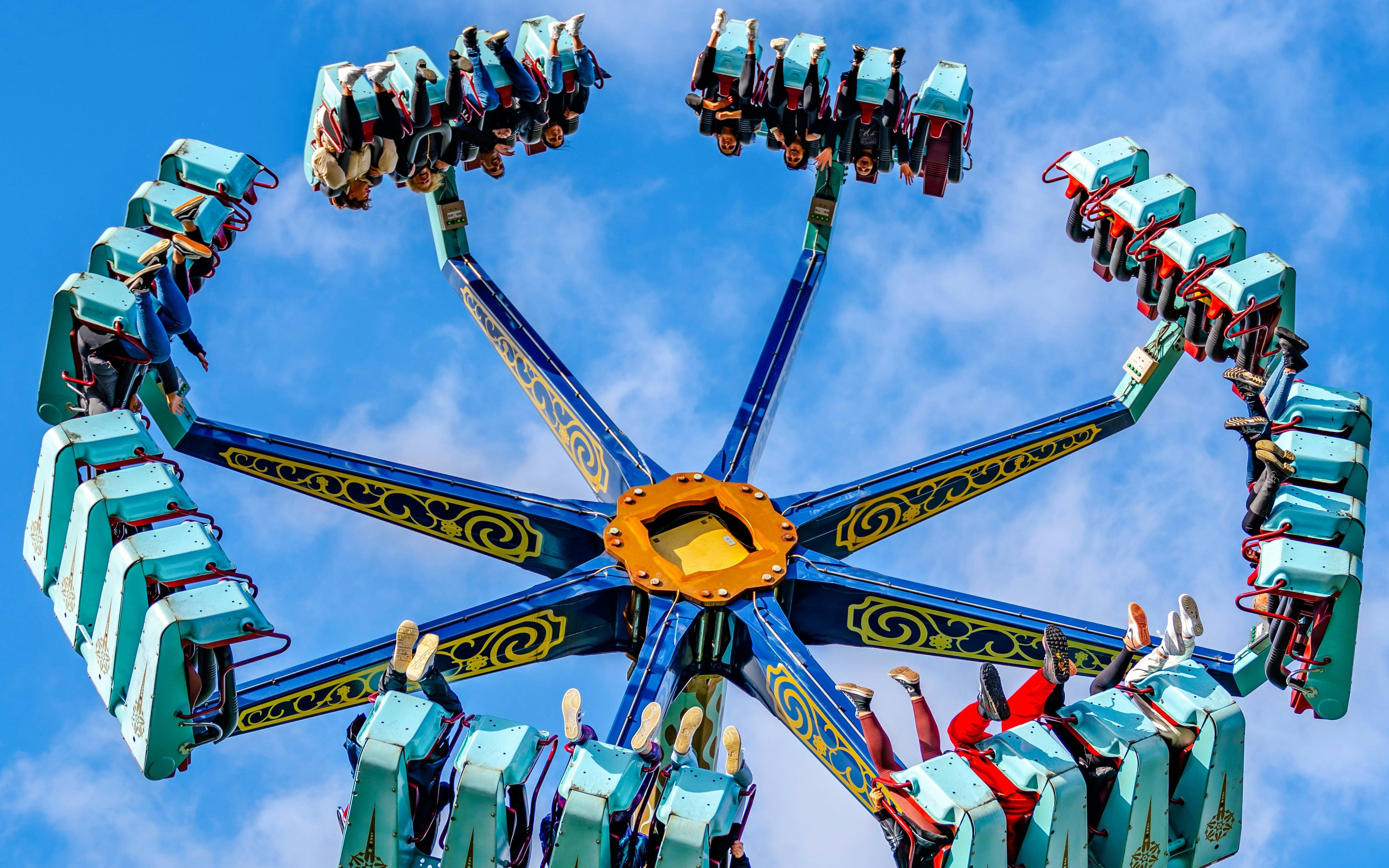 Vortex ride at Thorpe Park London with people upside down against a blue sky.