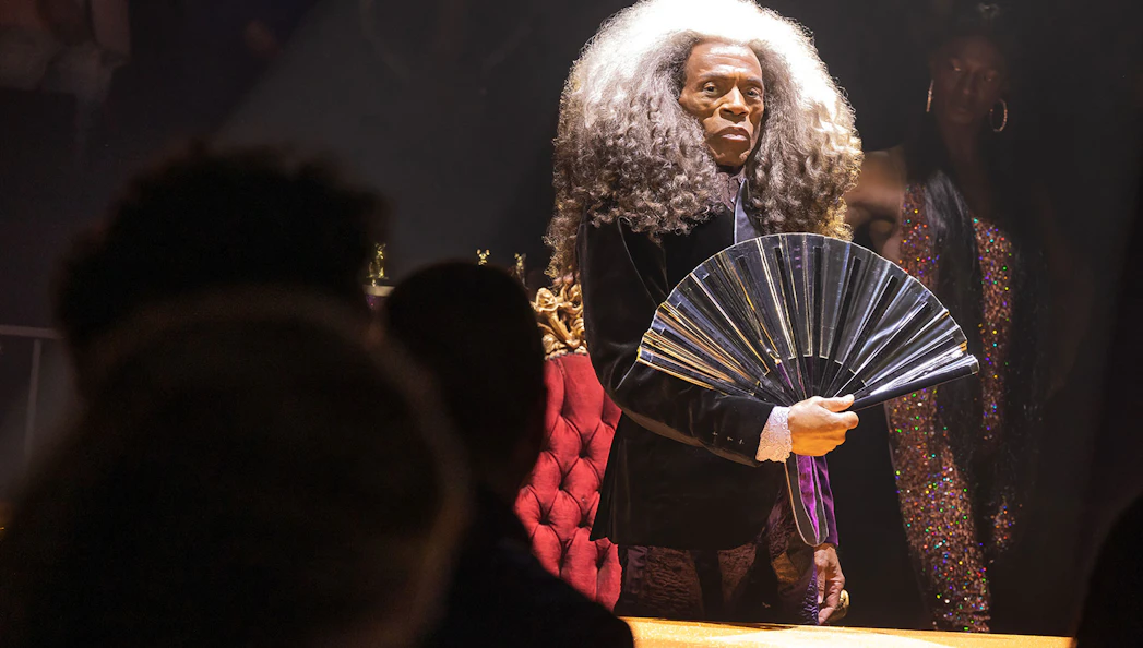 Performer with a fan during CATS: The Jellicle Ball Broadway show.