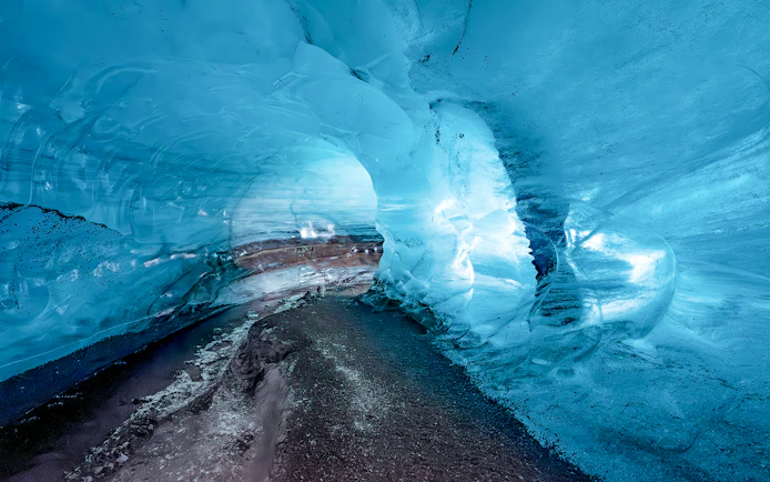 Ice cave interior with blue ice walls in Kötlujökull, Vik, Iceland.
