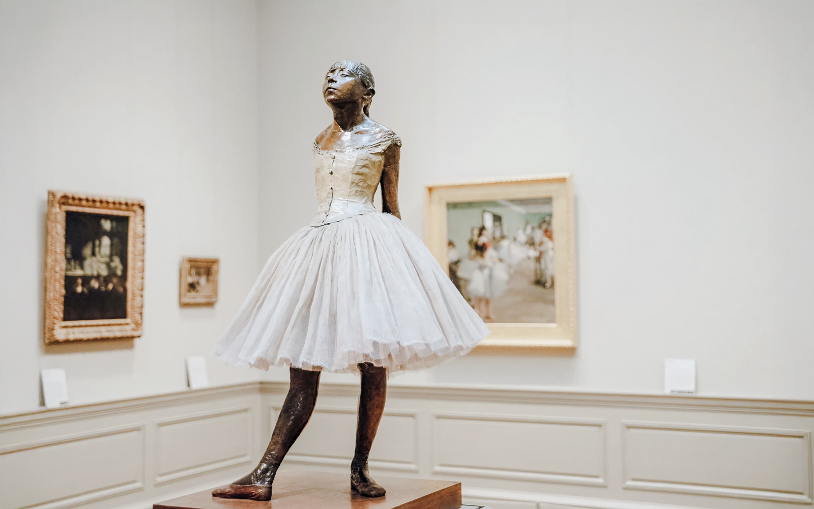 Bronze sculpture of a young ballerina in a white tutu at The Metropolitan Museum of Art.
