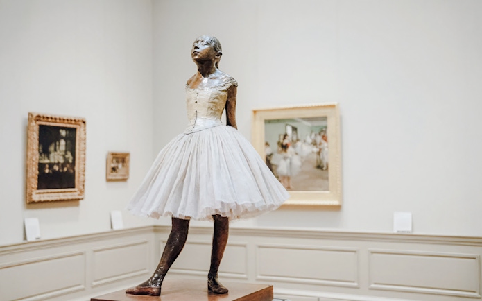 Bronze sculpture of a young ballerina in a white tutu at The Metropolitan Museum of Art.