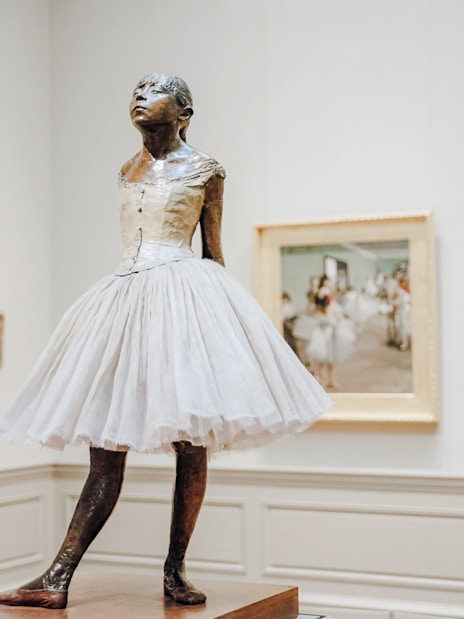 Bronze sculpture of a young ballerina in a white tutu at The Metropolitan Museum of Art.