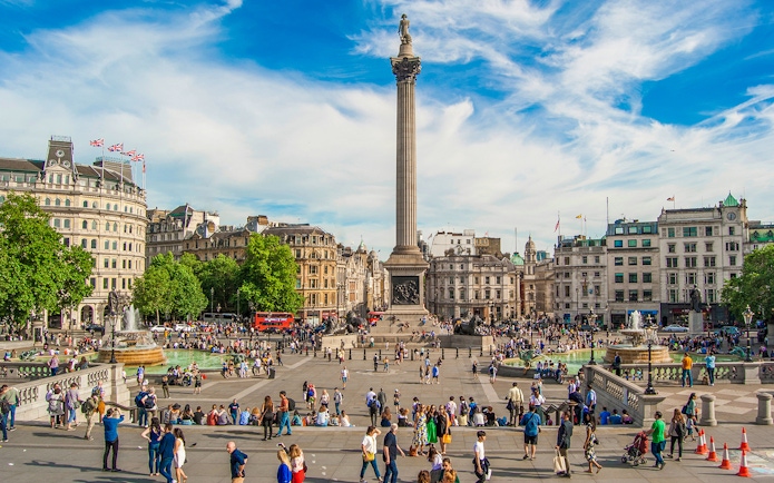 Tourists at Trafalgar Square with Nelson's Column during Westminster walking tour.