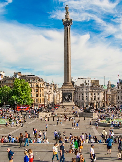 Tourists at Trafalgar Square with Nelson's Column during Westminster walking tour.