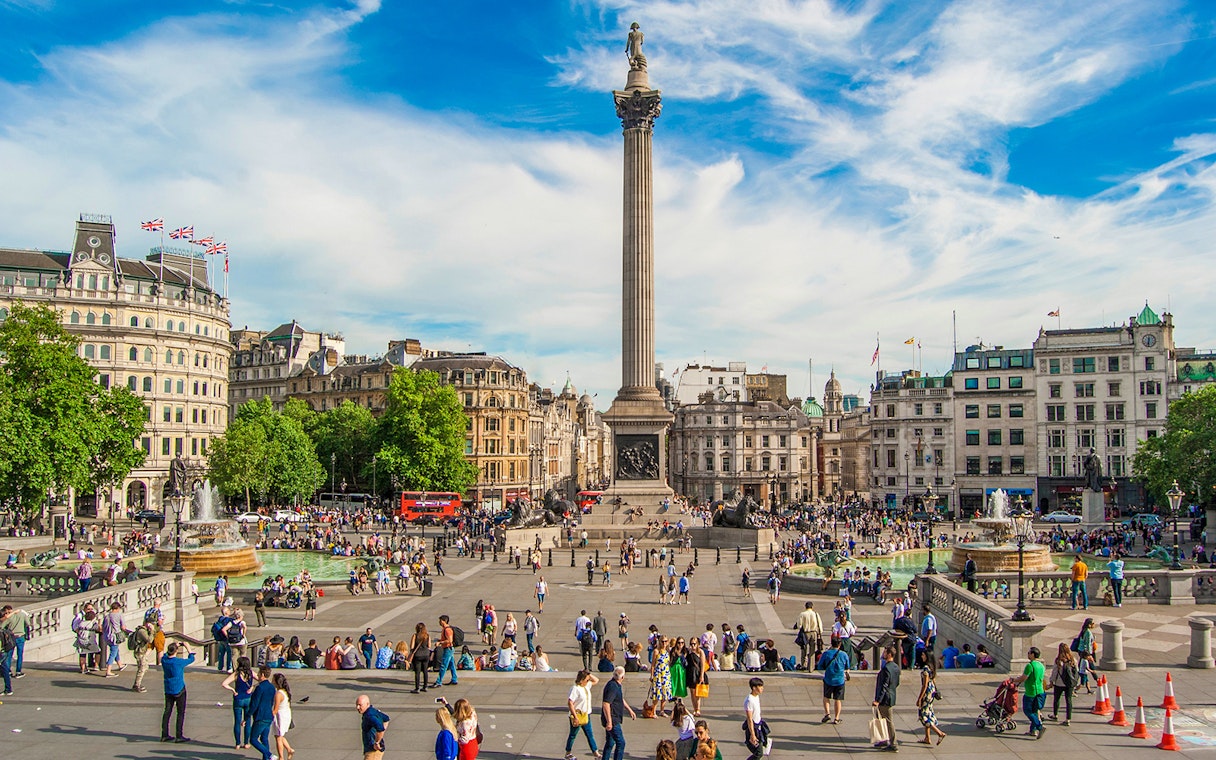 Tourists at Trafalgar Square with Nelson's Column during Westminster walking tour.