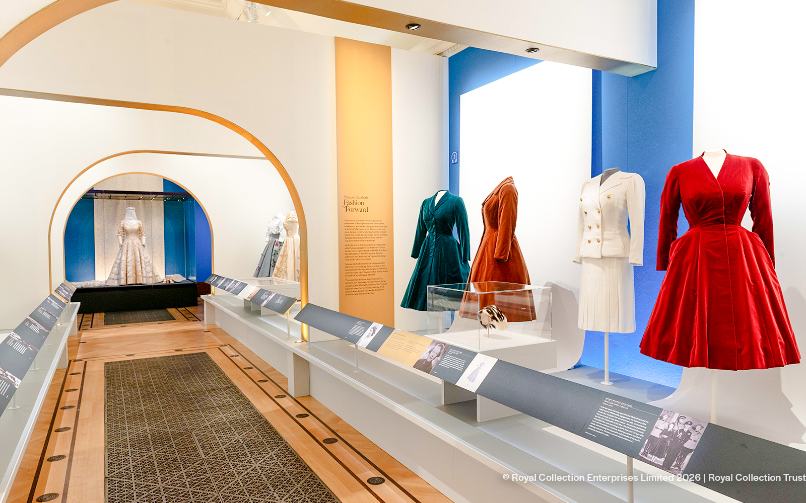 Fashion exhibit with dresses and suits at The King's Gallery, Buckingham Palace.