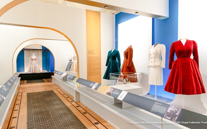 Fashion exhibit with dresses and suits at The King's Gallery, Buckingham Palace.