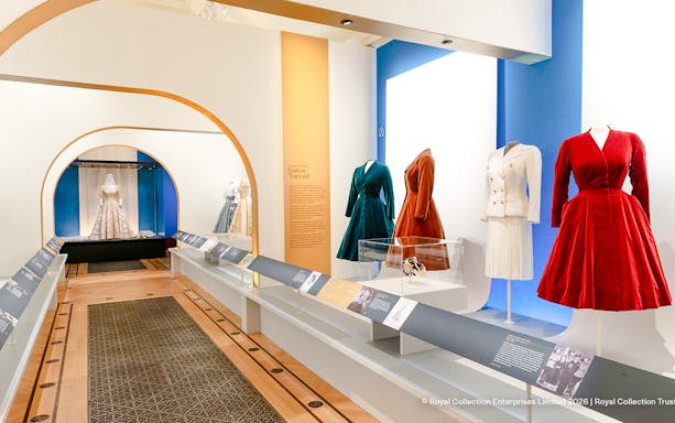 Fashion exhibit with dresses and suits at The King's Gallery, Buckingham Palace.