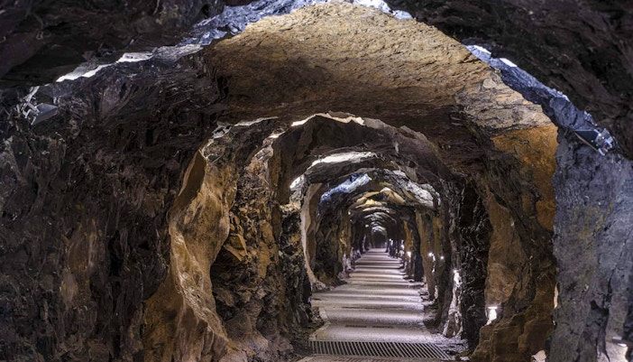 Aillwee Cave tunnel with illuminated rock walls in County Clare, Ireland.